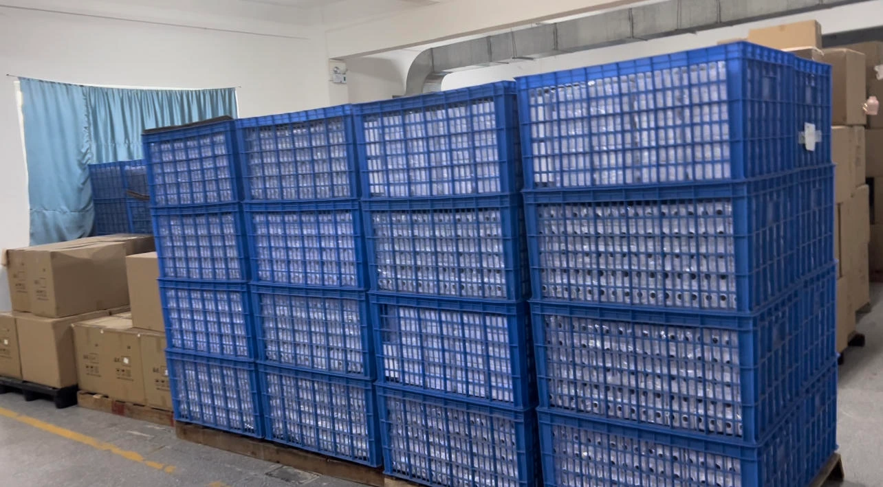 Blue storage crates beside packed cartons